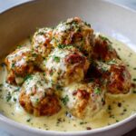 chicken meatballs swimming in garlicky Alfredo sauce
